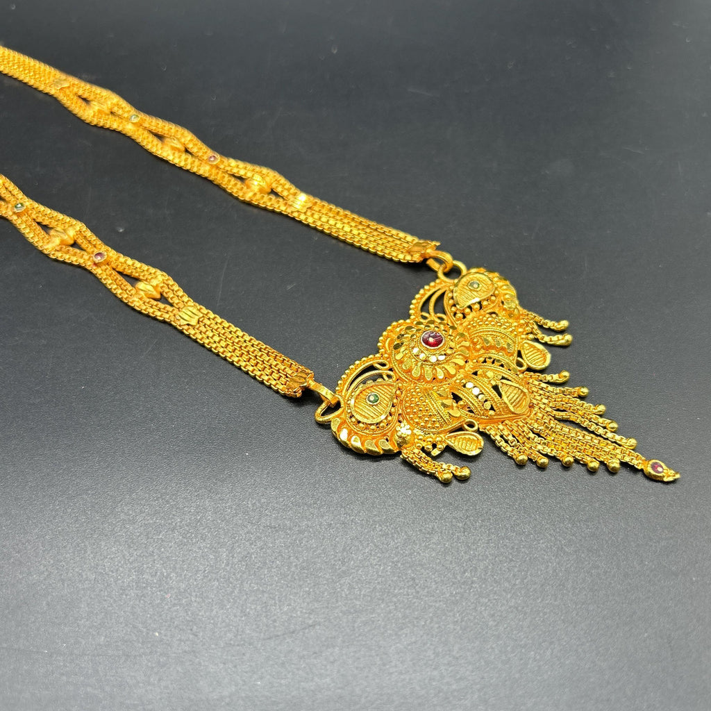 Gold-plated black beaded long mangalsutra, has a stylized centerpiece with textured details
